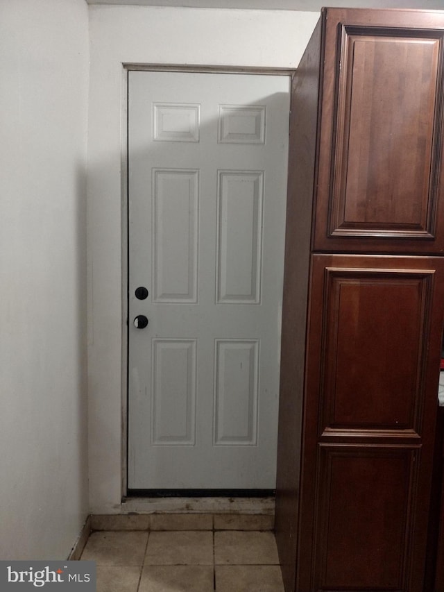 entryway with light tile patterned floors