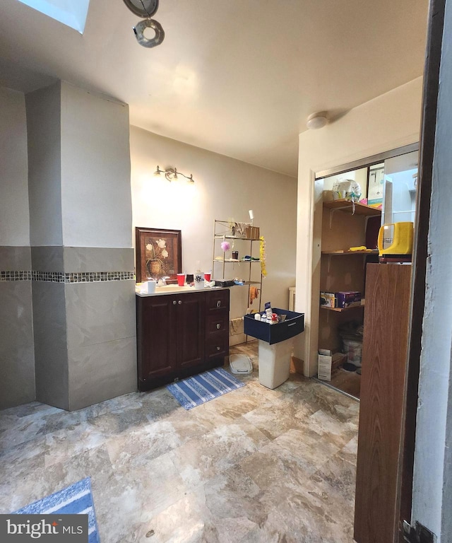 bathroom with a skylight and vanity