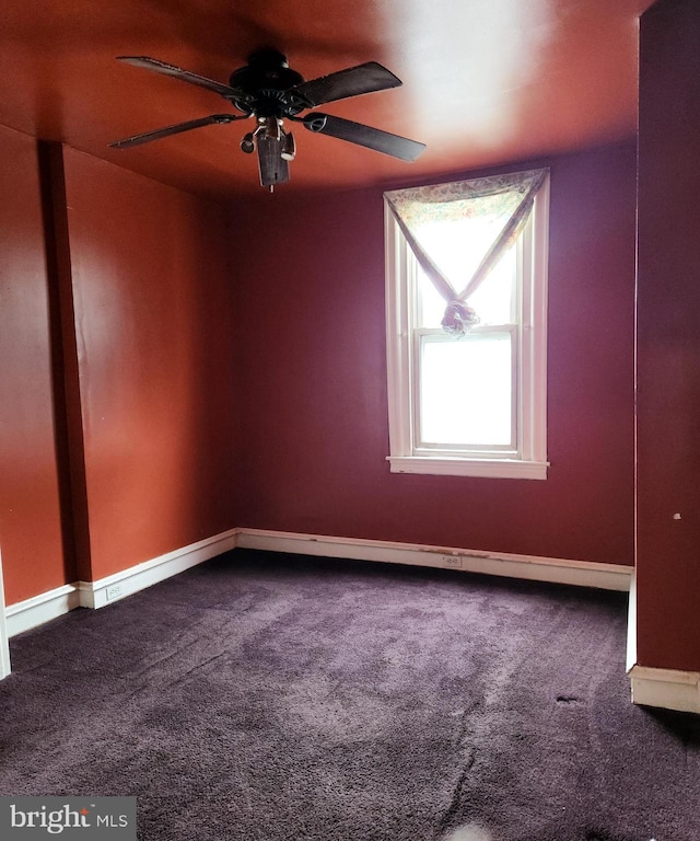 spare room featuring ceiling fan and carpet