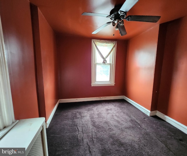 carpeted empty room featuring ceiling fan