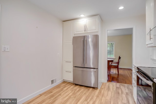 kitchen with white cabinets, visible vents, baseboards, and appliances with stainless steel finishes