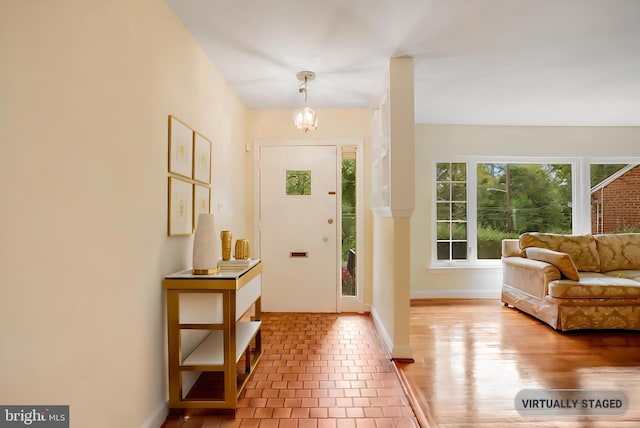 tiled foyer entrance with baseboards