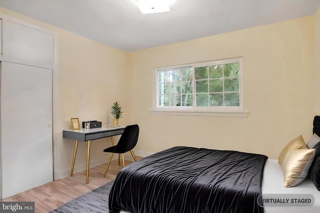 bedroom with baseboards and wood finished floors