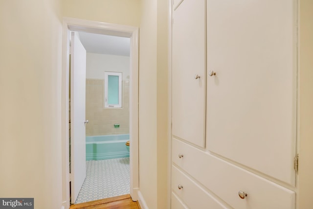 hallway with light hardwood / wood-style floors