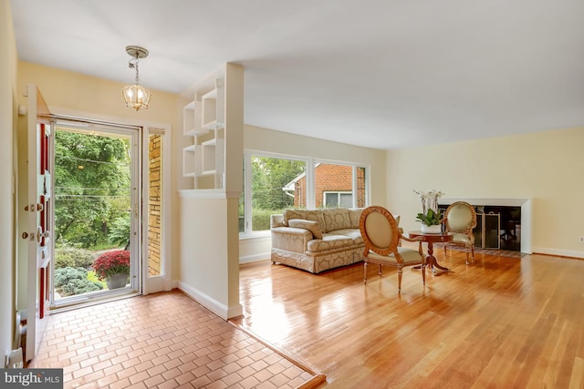 doorway featuring plenty of natural light, light hardwood / wood-style flooring, and a notable chandelier