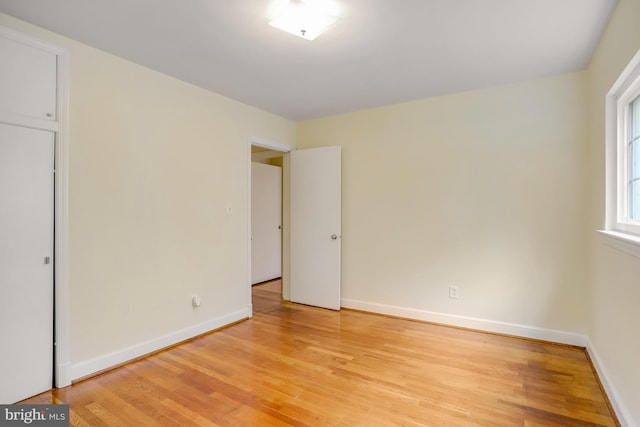 unfurnished bedroom featuring light wood-style flooring and baseboards