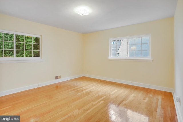 empty room featuring baseboards and wood finished floors
