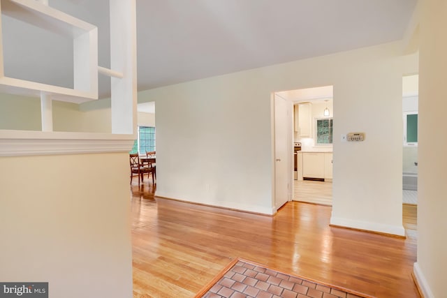 hallway with light hardwood / wood-style flooring