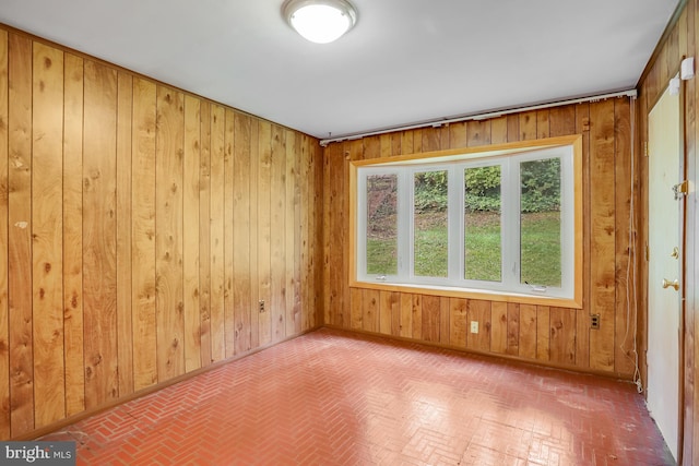 empty room featuring wooden walls