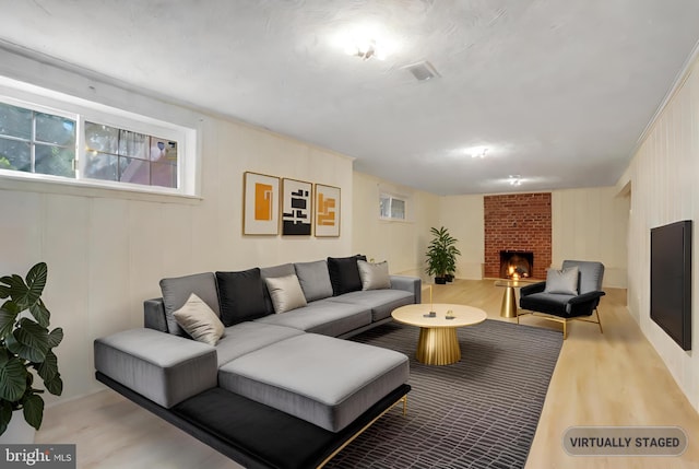 living area featuring wood finished floors and a fireplace