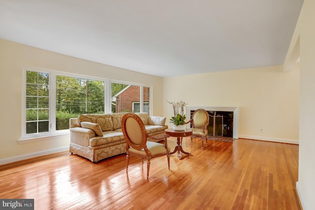 sitting room featuring light wood-style flooring and baseboards