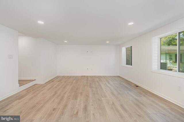 empty room with recessed lighting, baseboards, and light wood-style flooring