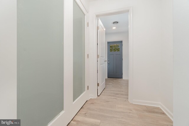 corridor with visible vents, recessed lighting, baseboards, and light wood-style floors