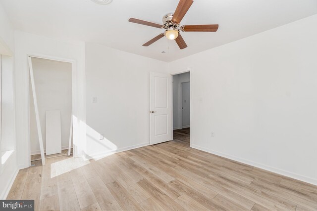 unfurnished room with baseboards, light wood finished floors, and ceiling fan