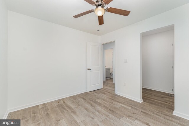 unfurnished bedroom with baseboards, ceiling fan, and light wood finished floors