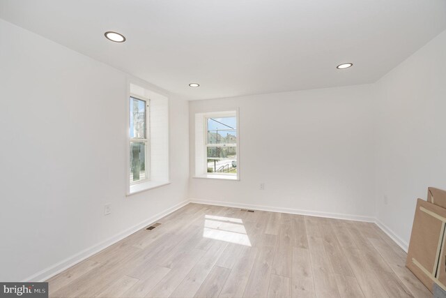 spare room featuring visible vents, recessed lighting, baseboards, and light wood-type flooring