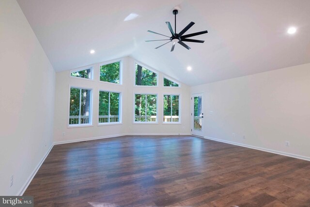 unfurnished living room featuring dark wood-type flooring, ceiling fan, and high vaulted ceiling