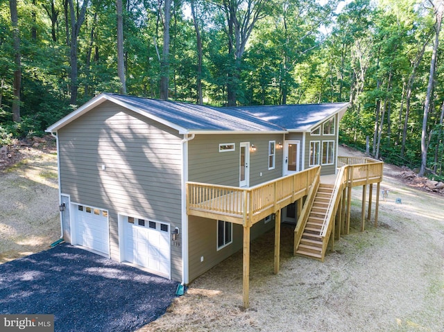 exterior space featuring a wooden deck and a garage