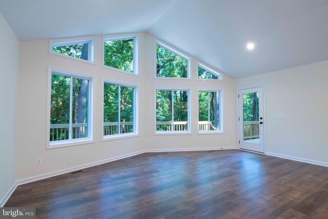 unfurnished living room with high vaulted ceiling and dark hardwood / wood-style floors