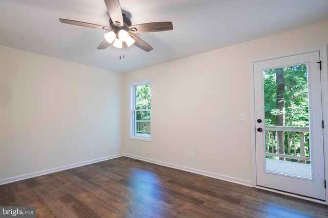 spare room featuring ceiling fan and dark hardwood / wood-style floors