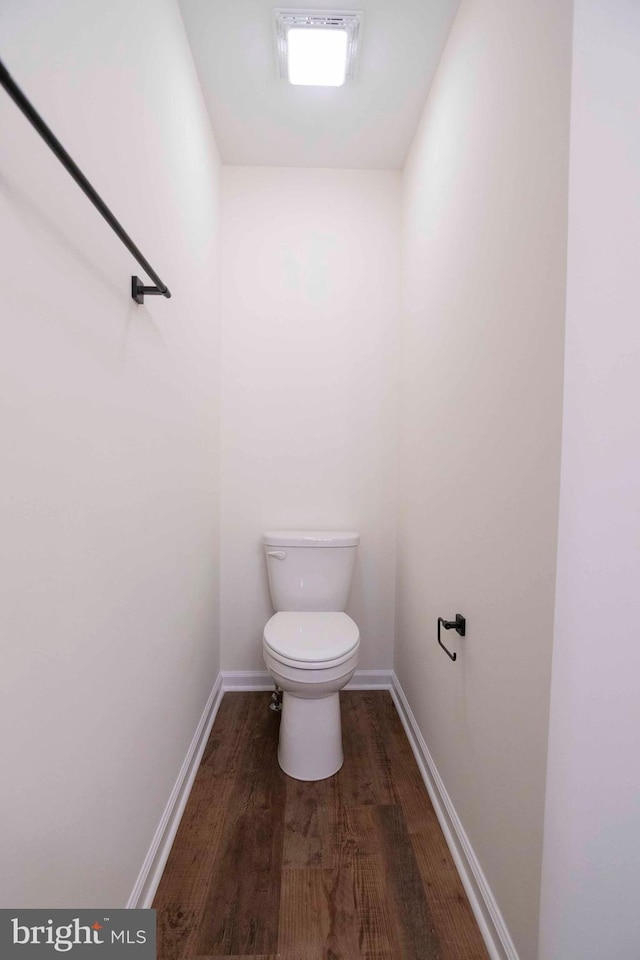 bathroom with toilet and hardwood / wood-style flooring