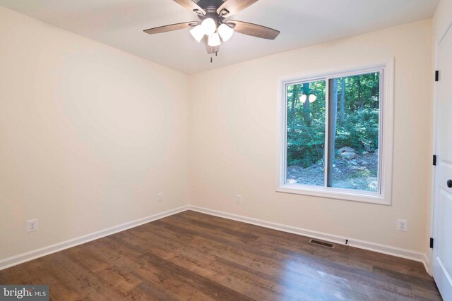 spare room featuring ceiling fan and dark hardwood / wood-style floors