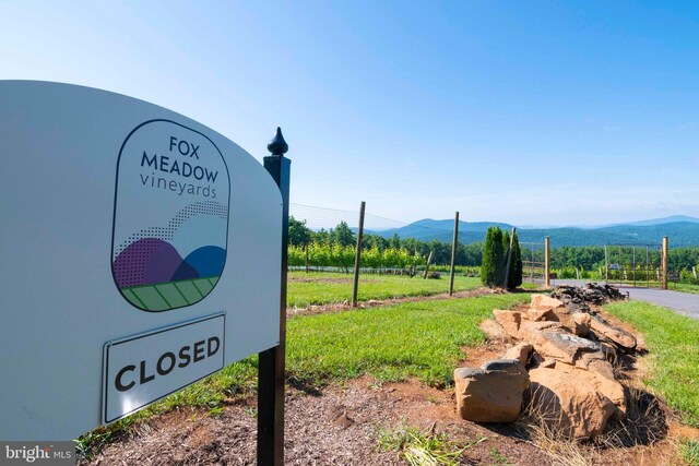 community sign with a mountain view