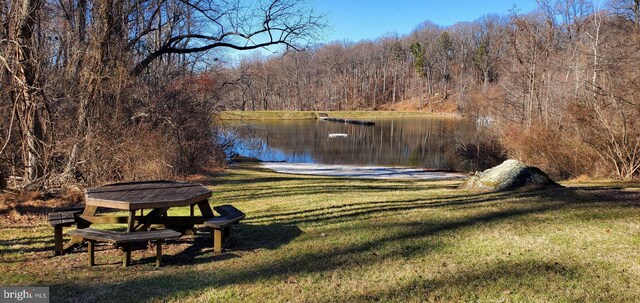 exterior space with a lawn and a water view