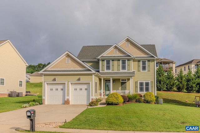 craftsman house featuring cooling unit, a front lawn, a garage, and a porch