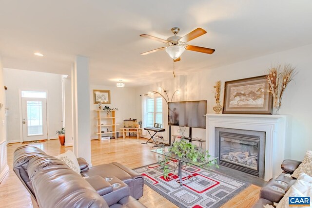 living room featuring wood-type flooring and ceiling fan