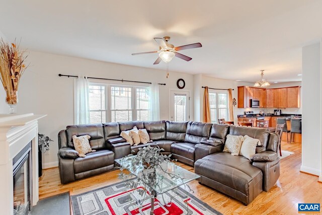 living room featuring ceiling fan and light wood-type flooring