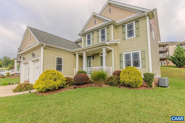 view of front of house with a garage, covered porch, central AC unit, and a front lawn