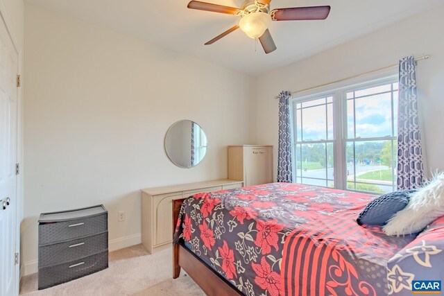 bedroom with light carpet and ceiling fan