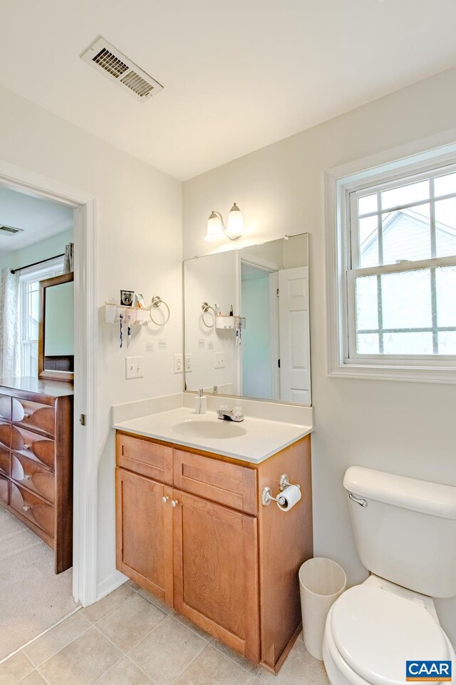 bathroom with vanity, toilet, and tile patterned floors