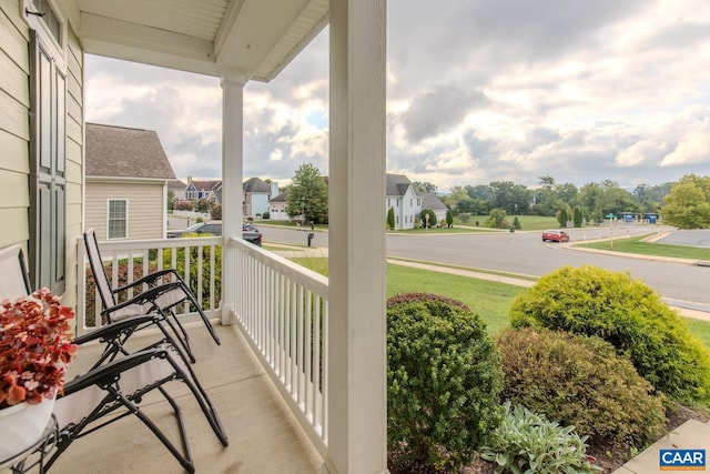 balcony featuring a residential view and covered porch