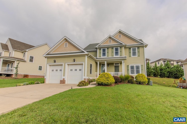 craftsman inspired home with a front yard, a garage, and a porch