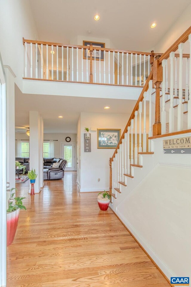 stairs with hardwood / wood-style flooring