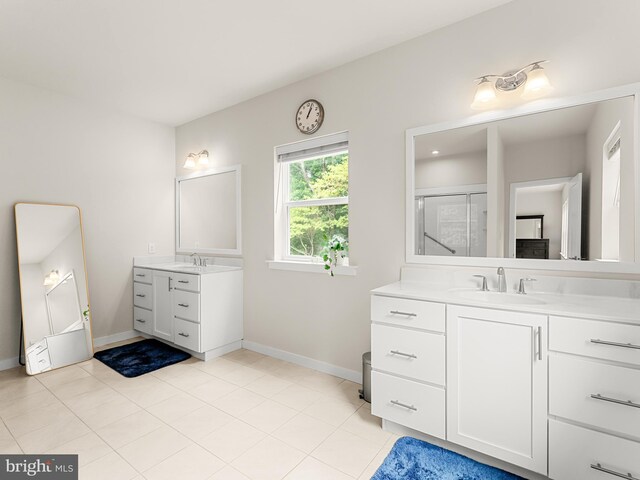 bathroom featuring vanity, tile patterned floors, and walk in shower