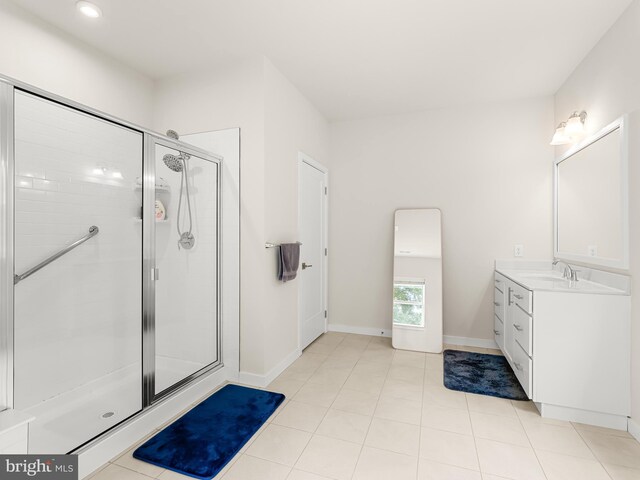 bathroom with a shower with shower door, tile patterned flooring, and vanity