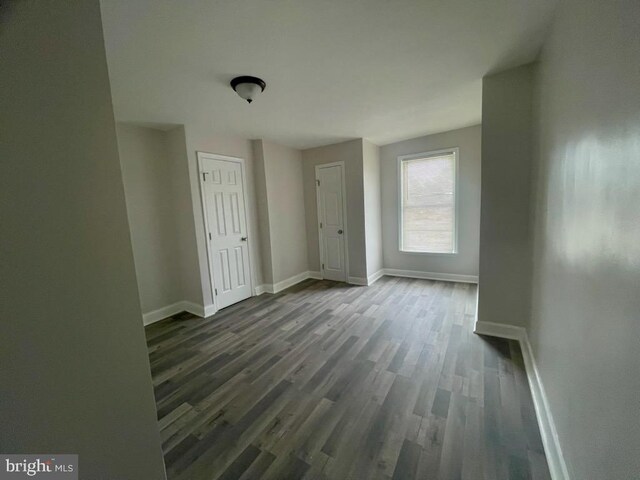 spare room with dark hardwood / wood-style flooring