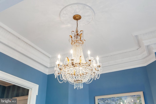 room details featuring ornamental molding and a chandelier