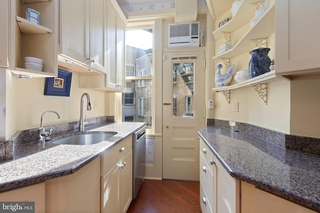 kitchen featuring stainless steel dishwasher, dark stone countertops, dark hardwood / wood-style flooring, and sink