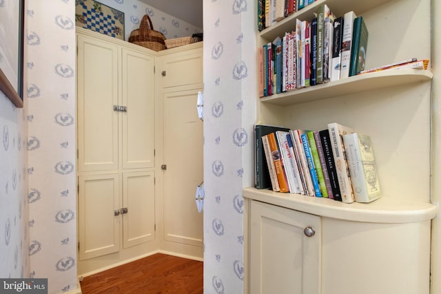 room details with wood finished floors and wallpapered walls