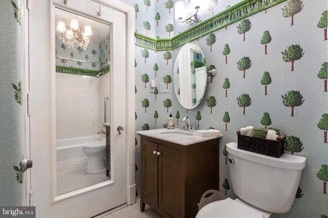 full bathroom featuring vanity, toilet, a chandelier, and tiled shower / bath