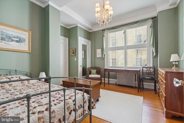 bedroom featuring radiator heating unit, light wood-type flooring, crown molding, and an inviting chandelier