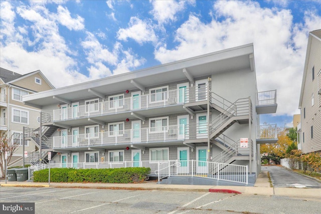 view of building exterior with uncovered parking