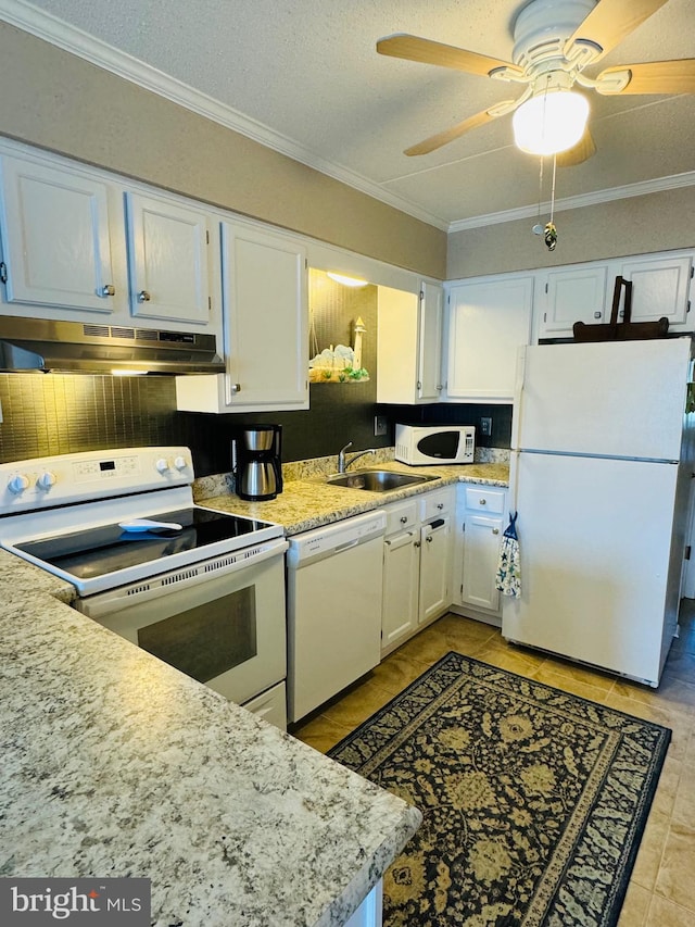 kitchen featuring white appliances, white cabinets, a sink, and under cabinet range hood