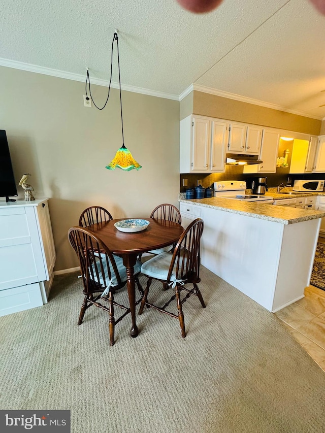 dining space featuring a textured ceiling, ornamental molding, baseboards, and light colored carpet