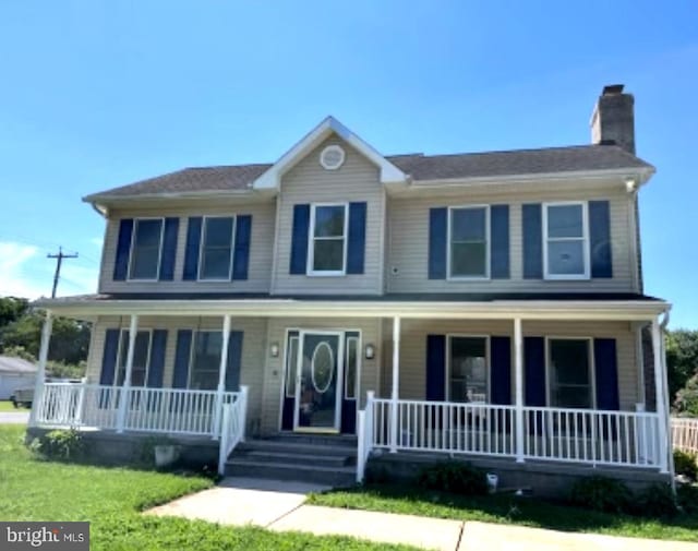 view of front of property with a porch and a front yard