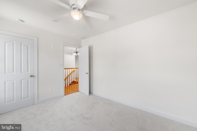 unfurnished bedroom with ceiling fan and light carpet